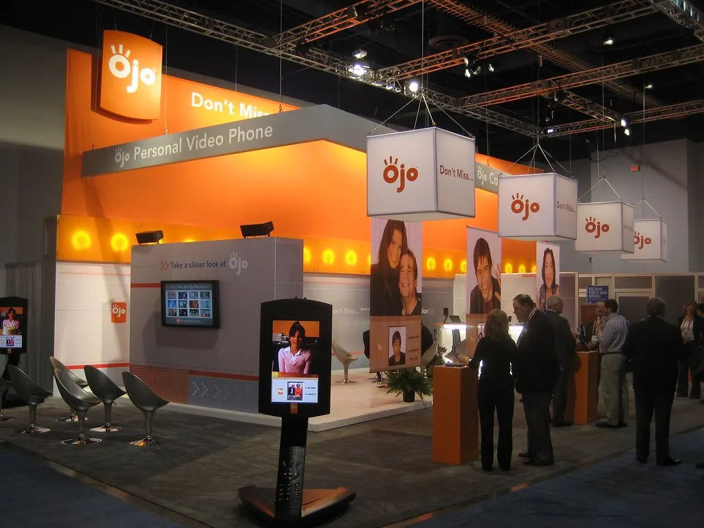 Custom exhibition stand with branded walls and a reception area at a trade show