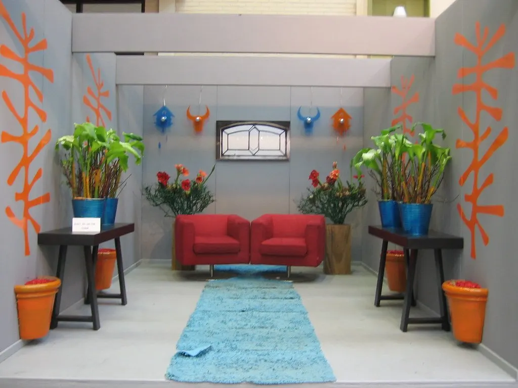 Furnished stand interior with seating, planters and a feature screen