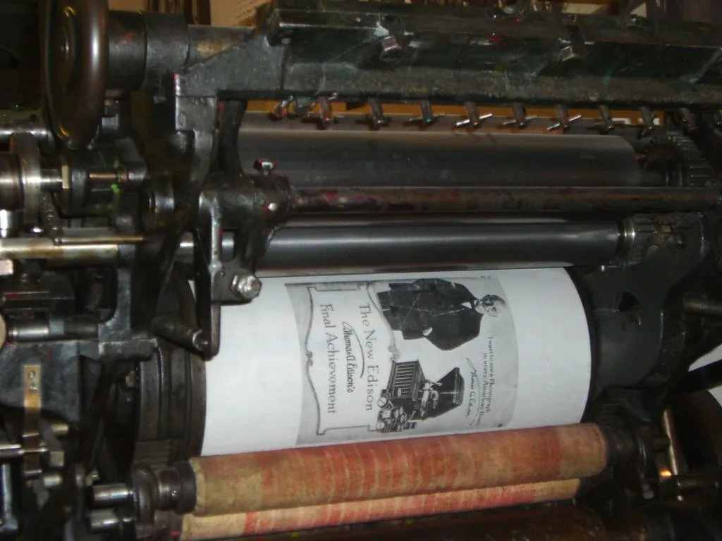 Large printing press with a roll of printed material